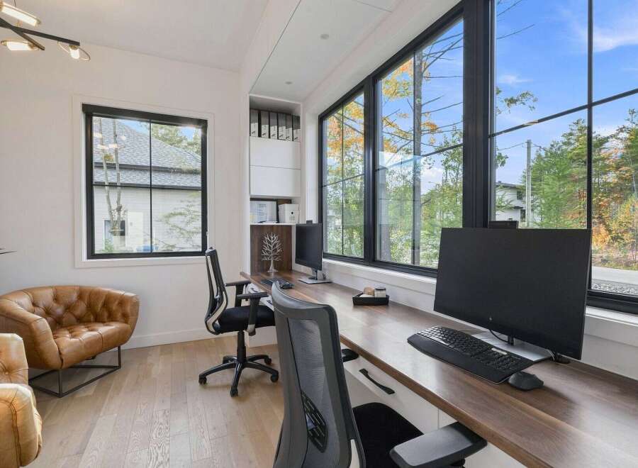 This modern home office boasts a spacious L-shaped desk with dual workstations, perfect for productivity.