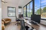 This modern home office boasts a spacious L-shaped desk with dual workstations, perfect for productivity.