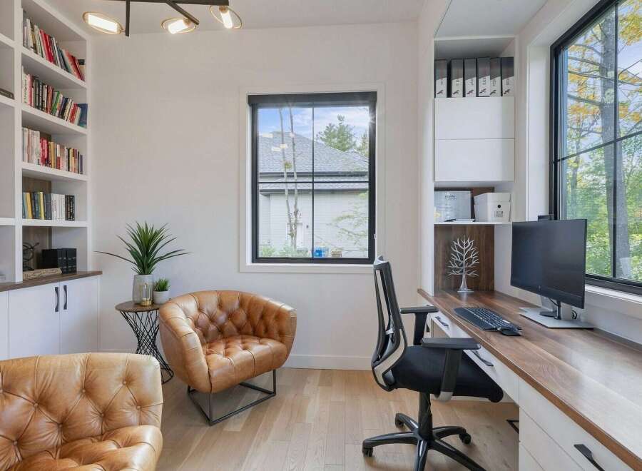 This modern home office features a spacious built-in desk with a wooden countertop, perfect for productivity.