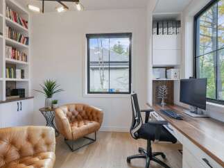 This modern home office features a spacious built-in desk with a wooden countertop, perfect for productivity.