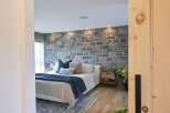 Experience rustic charm and modern comfort in this beautifully appointed bedroom.