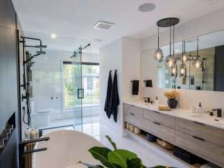 Experience modern luxury in this stunning bathroom, featuring a spacious walk-in shower with multiple showerheads and a freestanding soaking tub.