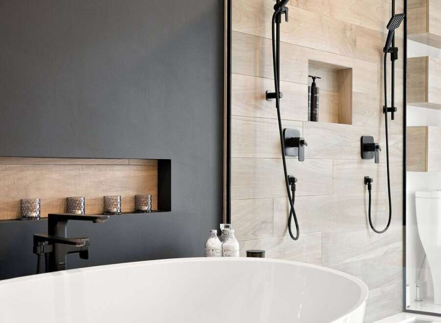 Experience modern luxury in this stunning bathroom, featuring a sleek freestanding bathtub and a spacious walk-in shower with elegant wood-look tile.