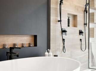 Experience modern luxury in this stunning bathroom, featuring a sleek freestanding bathtub and a spacious walk-in shower with elegant wood-look tile.