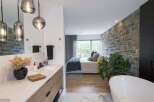 Experience luxury living in this stunning master suite, seamlessly blending a spa-like bathroom with a serene bedroom.