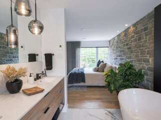 Experience luxury living in this stunning master suite, seamlessly blending a spa-like bathroom with a serene bedroom.