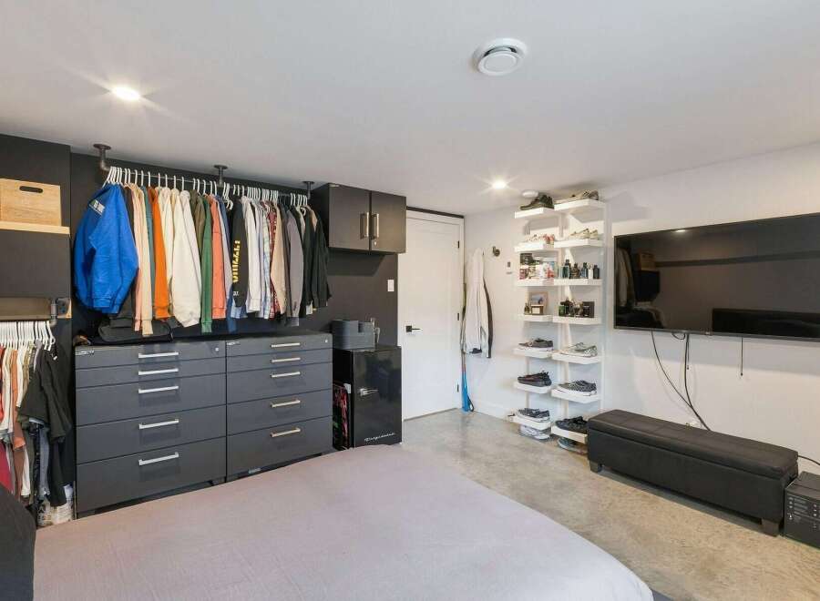 Discover organized living with this spacious bedroom featuring ample storage solutions.