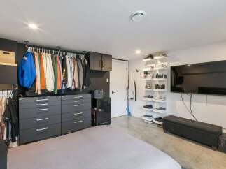 Discover organized living with this spacious bedroom featuring ample storage solutions.