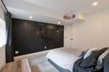 This modern bedroom features a unique chalkboard wall, perfect for creative expression or leaving notes.