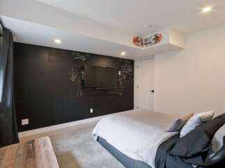 This modern bedroom features a unique chalkboard wall, perfect for creative expression or leaving notes.