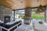 Experience luxurious outdoor living with this stunning covered patio, featuring a cozy fireplace and a state-of-the-art grill perfect for entertaining.