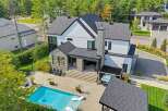 Experience luxury living in this stunning modern home featuring a pristine swimming pool and a relaxing hot tub, perfect for unwinding.