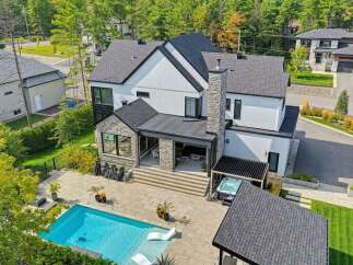 Experience luxury living in this stunning modern home featuring a pristine swimming pool and a relaxing hot tub, perfect for unwinding.