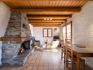 Experience rustic charm in this cozy living space featuring a magnificent stone fireplace as the centerpiece.