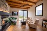 Experience ultimate relaxation in this cozy living room, featuring a modern fireplace and plush green sofa.