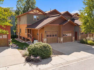 Discover this charming multi-unit property featuring a warm, natural wood exterior complemented by rich brown roofing and trim.