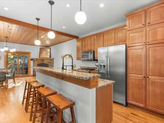 This inviting kitchen boasts a spacious island with granite countertops, perfect for casual dining and entertaining.