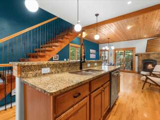 Experience the perfect blend of rustic charm and modern convenience in this stunning kitchen and living area.