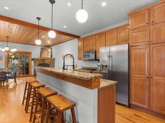 This inviting kitchen boasts a spacious island with granite countertops, perfect for casual dining and entertaining.