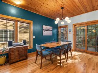 Experience cozy dining in this charming room featuring a warm wooden ceiling and rich hardwood floors.