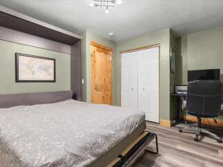 This versatile room features a murphy bed, perfect for maximizing space in a guest room or studio apartment.