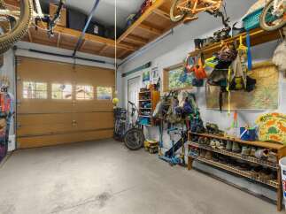 This spacious garage offers ample storage solutions for all your recreational gear, including skis, snowboards, bikes, and scooters.