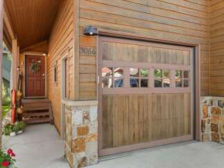 Charming mountain home featuring a rustic wood exterior and stone accents.