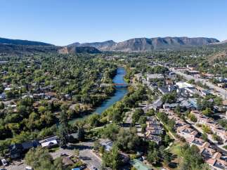 Discover this charming town nestled beside a serene river, offering a picturesque setting with lush greenery and majestic mountains.