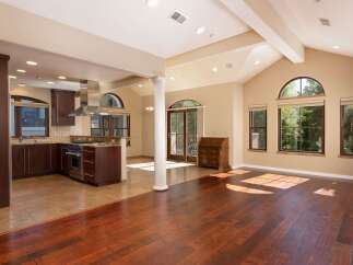 Experience the best of open-concept living in this stunning home, featuring a gourmet kitchen with rich wood cabinetry and stainless steel appliances.