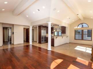 Experience open-concept living in this stunning home, featuring a spacious living area with rich hardwood floors that seamlessly transitions into a gourmet kitchen.