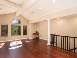 Experience breathtaking views from this spacious room featuring a vaulted ceiling and large windows that flood the space with natural light.