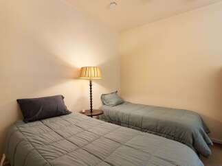 This cozy bedroom features two comfortable twin beds, perfect for accommodating guests or family.