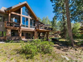 Experience mountain living in this stunning timber-frame home, featuring expansive windows that capture breathtaking natural light and scenic views.