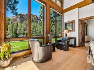 Experience breathtaking mountain views from this stunning living area, featuring expansive windows that flood the space with natural light.