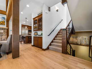 Experience luxury mountain living in this stunning home featuring a gourmet kitchen with stainless steel appliances and a spacious living area with a stone fireplace.