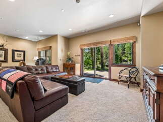 Step into this inviting living space featuring a luxurious brown leather sectional sofa, perfect for relaxation and entertaining.