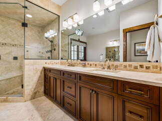 Experience luxury in this stunning bathroom featuring a spacious glass-enclosed shower with elegant tilework.