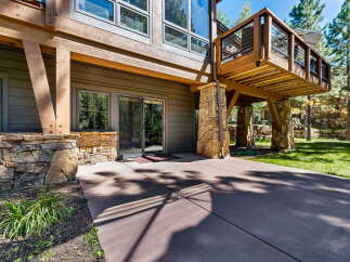 Experience seamless indoor-outdoor living with this stunning property, featuring a spacious concrete patio perfect for entertaining or relaxing.