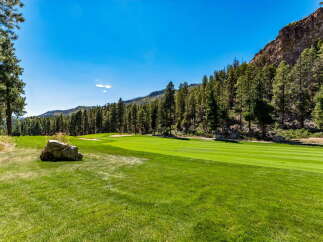 Experience luxury living with this stunning golf course view, nestled against a majestic mountain backdrop.