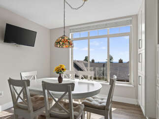 Enjoy bright and airy dining with this charming space featuring a white oval dining table and chairs, perfect for intimate meals.