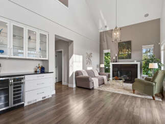 Experience elegant living in this spacious great room, featuring a modern wet bar with wine fridge and ample storage.