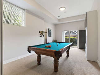 Enjoy endless entertainment in this dedicated game room, featuring a classic billiard table perfect for friendly competitions.