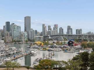 Experience waterfront living at its finest with this stunning property overlooking a vibrant marina and a dynamic cityscape.