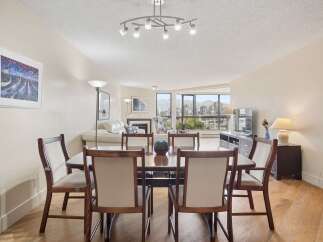 Experience breathtaking city and mountain views from this elegant dining area, perfect for hosting gatherings.