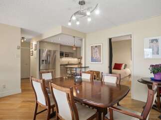 This inviting dining area features a rich, dark wood dining table with upholstered chairs, perfect for family meals.