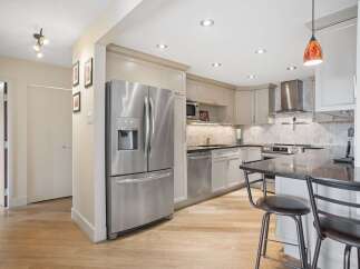 Experience modern living in this beautifully updated kitchen, featuring sleek stainless steel appliances, elegant cabinetry, and a spacious island perfect for casual dining.