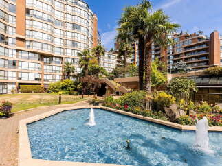 Discover resort-style living with this stunning property featuring a serene water fountain and lush landscaping.