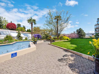 Enjoy the vibrant outdoor living spaces of this property, featuring a serene fountain and lush landscaping.