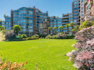 Experience luxury living in this stunning waterfront property featuring expansive glass windows that offer breathtaking ocean views.