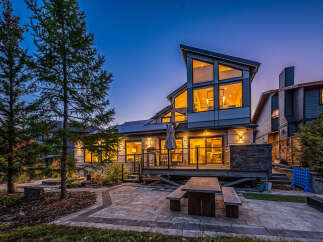 Experience modern luxury in this stunning home featuring a multi-level deck and a spacious patio perfect for entertaining.